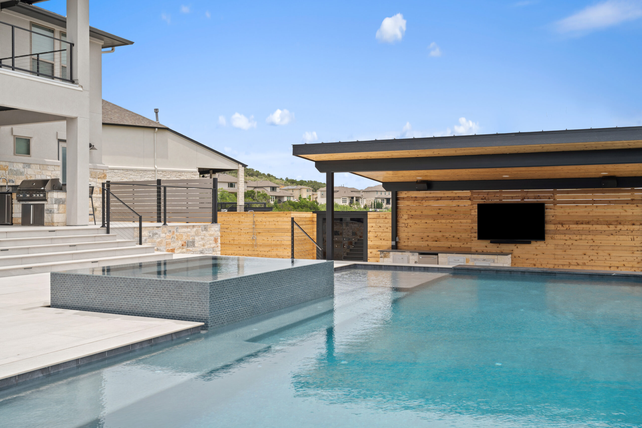 Modern pool design in Austin featuring clean lines and neutral finishes by Wild Basin Pools