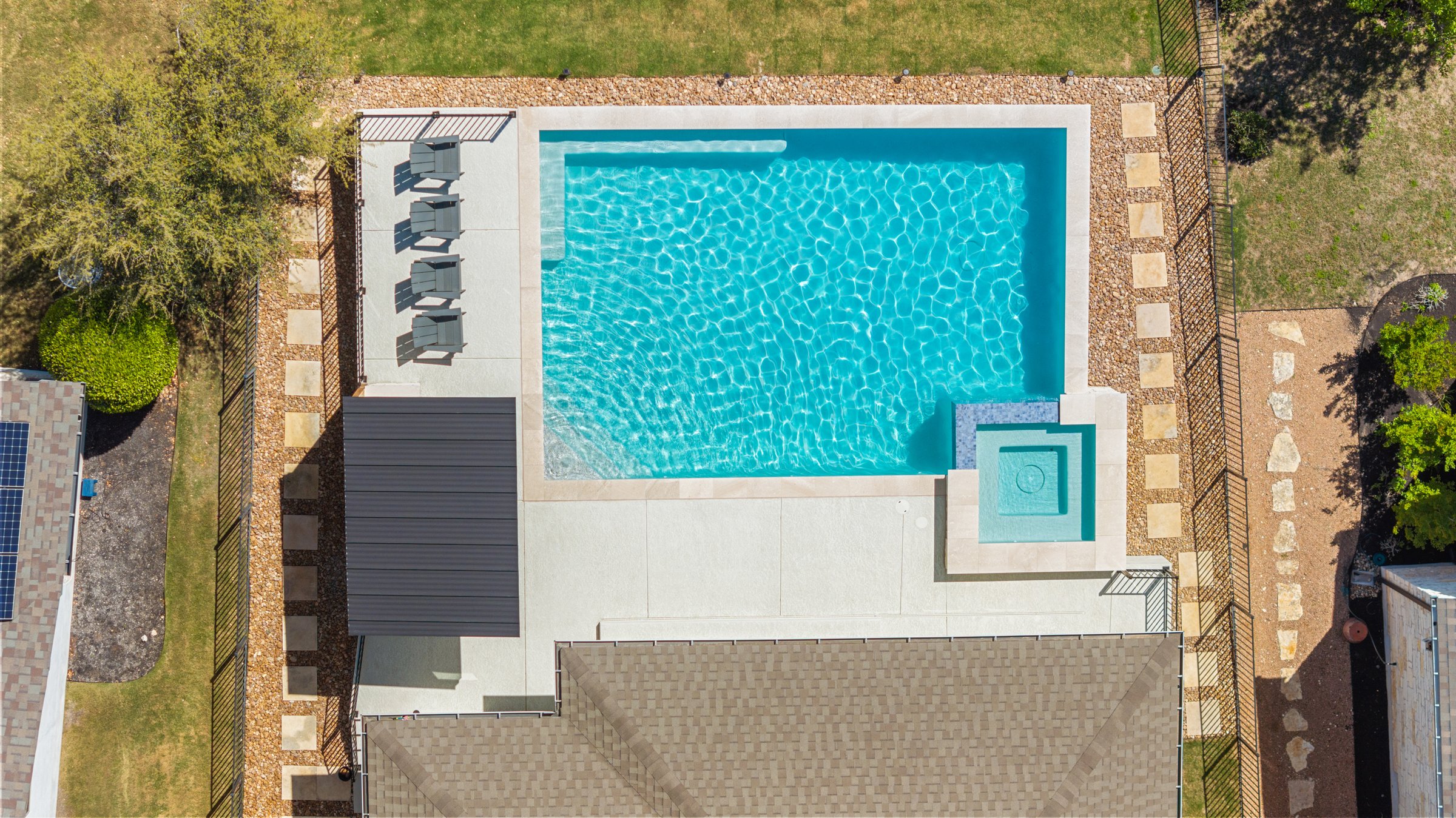 Top down aerial of Azure Terrace geometric pool and raised spa layout by Wild Basin Pools Austin TX