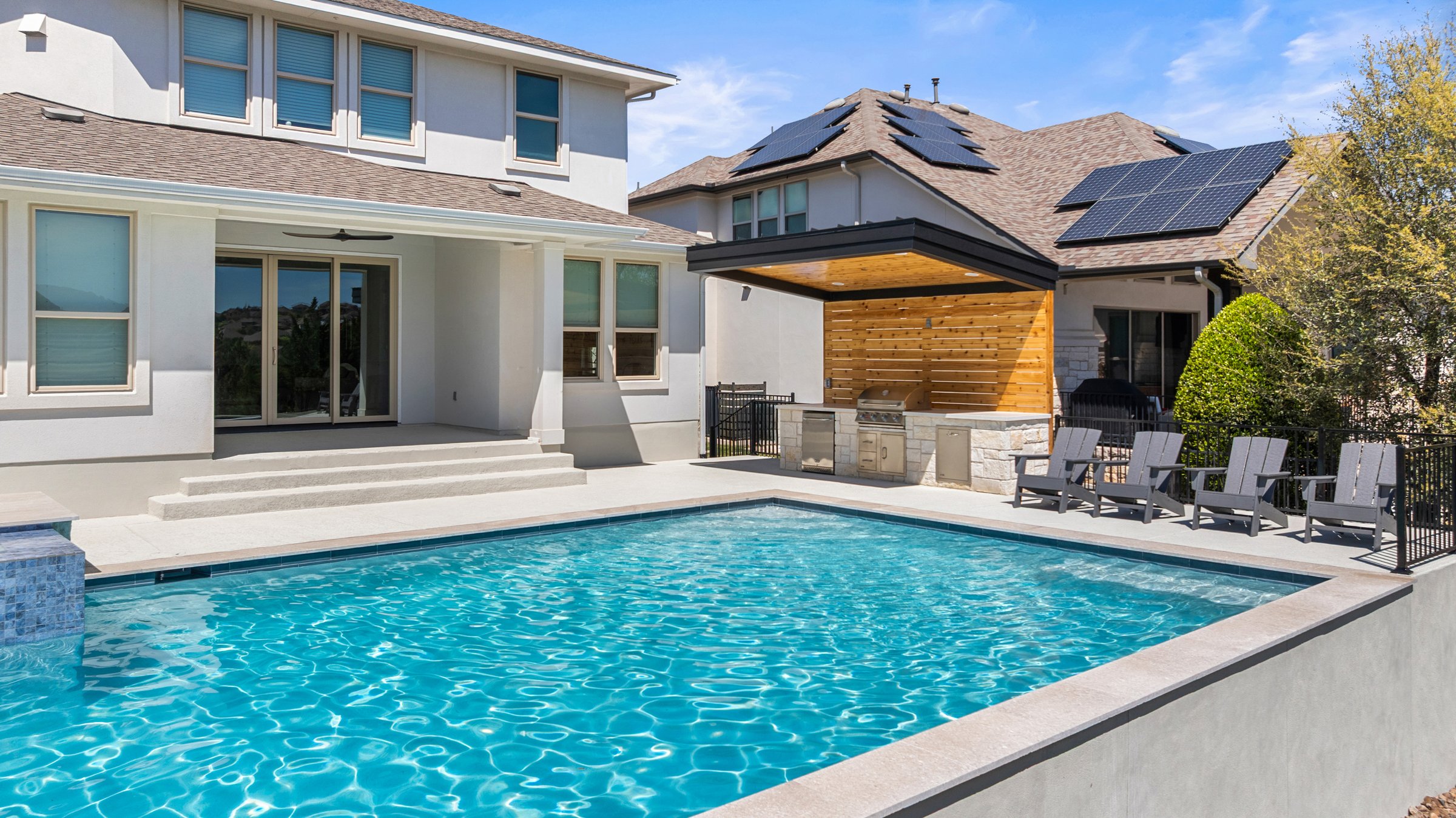 Azure Terrace geometric pool and raised spa with outdoor kitchen pergola by Wild Basin Pools in Austin TX