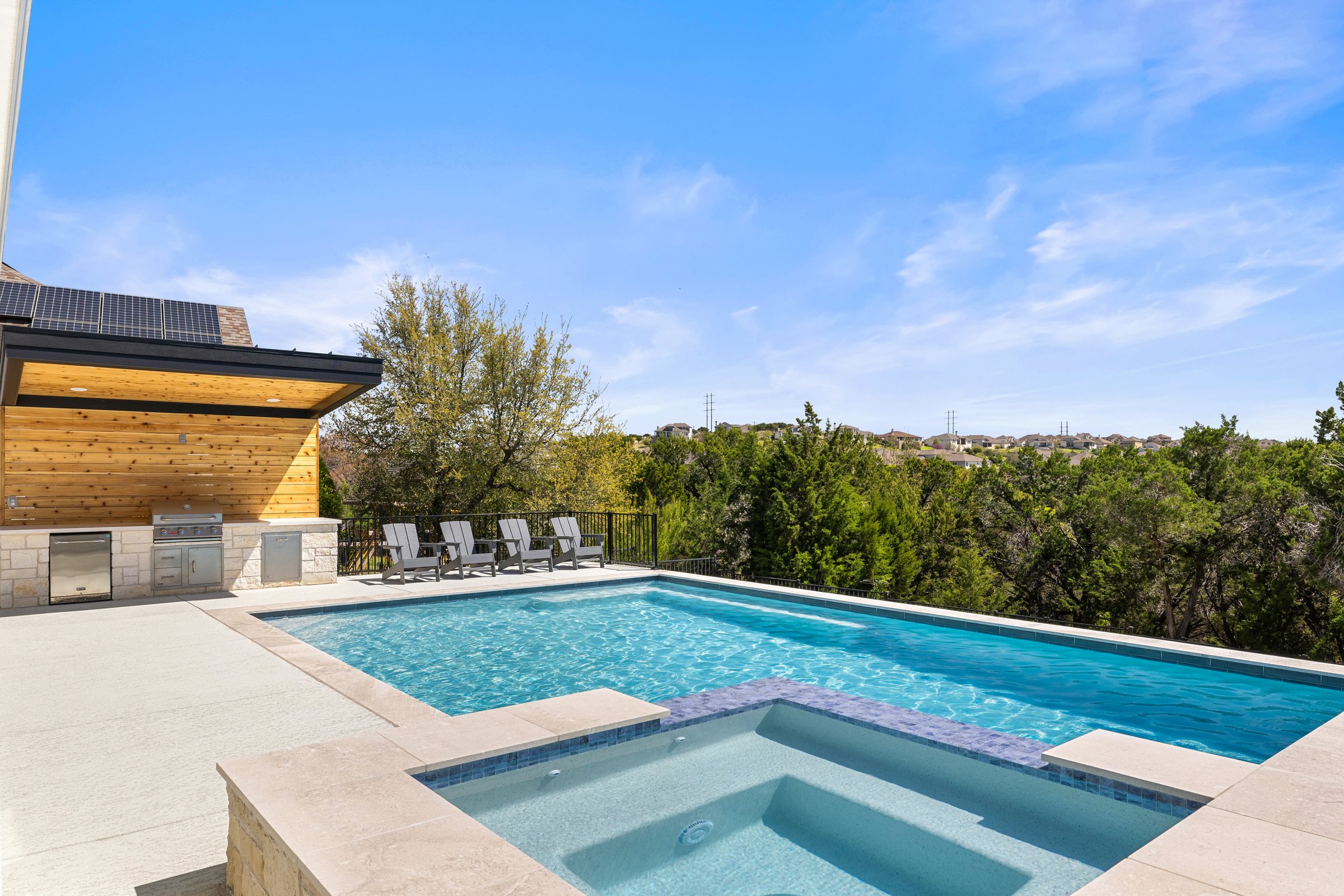 Aerial view of Azure Terrace pool deck with outdoor kitchen and lounge area by Wild Basin Pools Austin TX