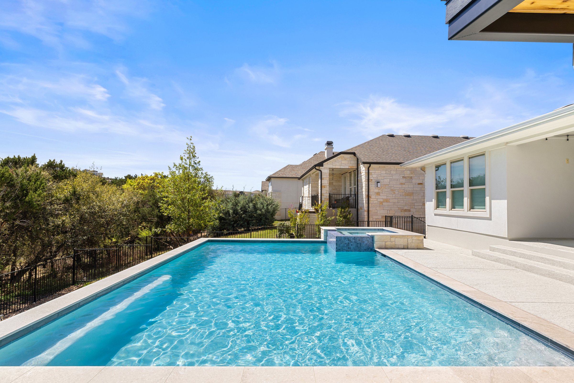 Azure Terrace modern pool and raised spa surrounded by lush Hill Country greenery in Austin TX