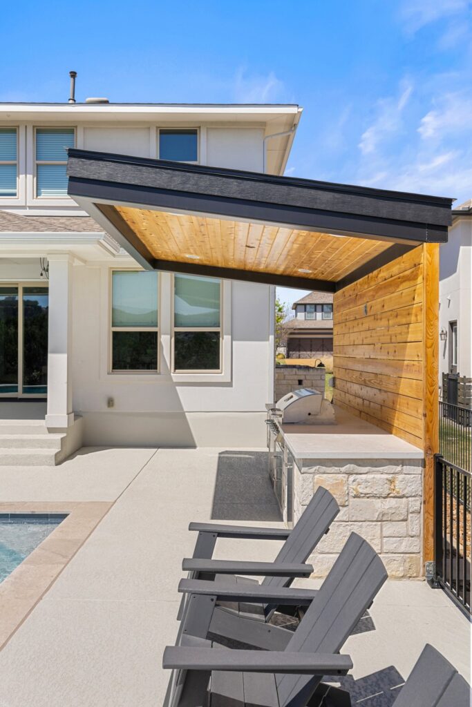 Azure Terrace outdoor kitchen and cedar pergola with stone base by Wild Basin Pools in Austin TX