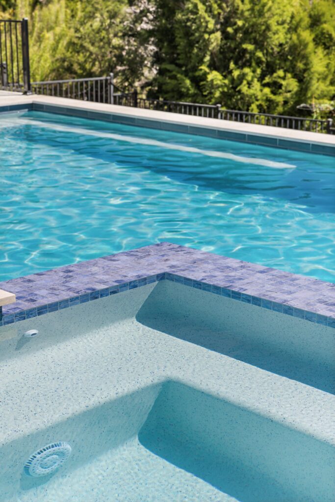 Azure Terrace spa and tanning ledge with crystal blue water detail by Wild Basin Pools in Austin TX